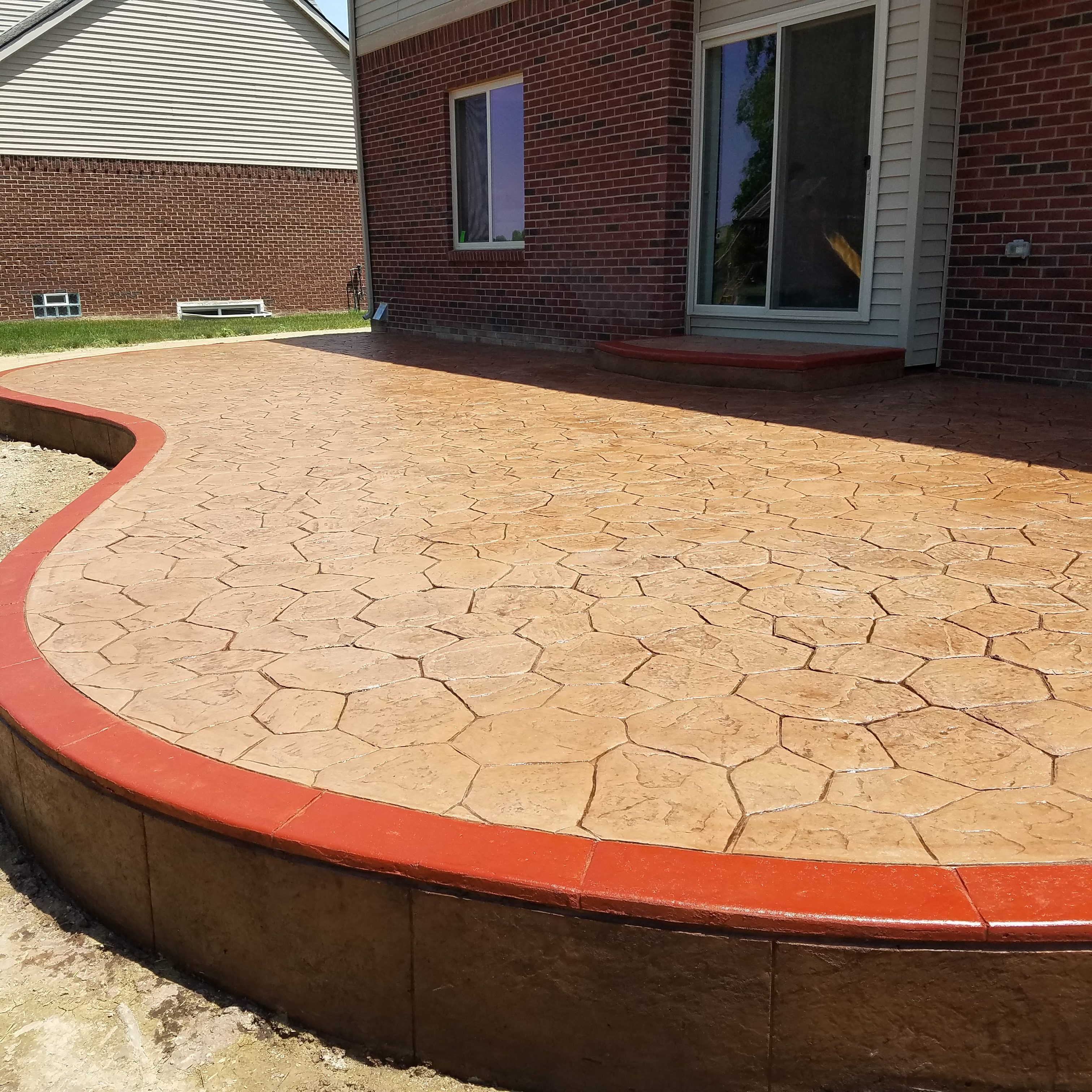 stamped patio with stained borders Rolland Cement